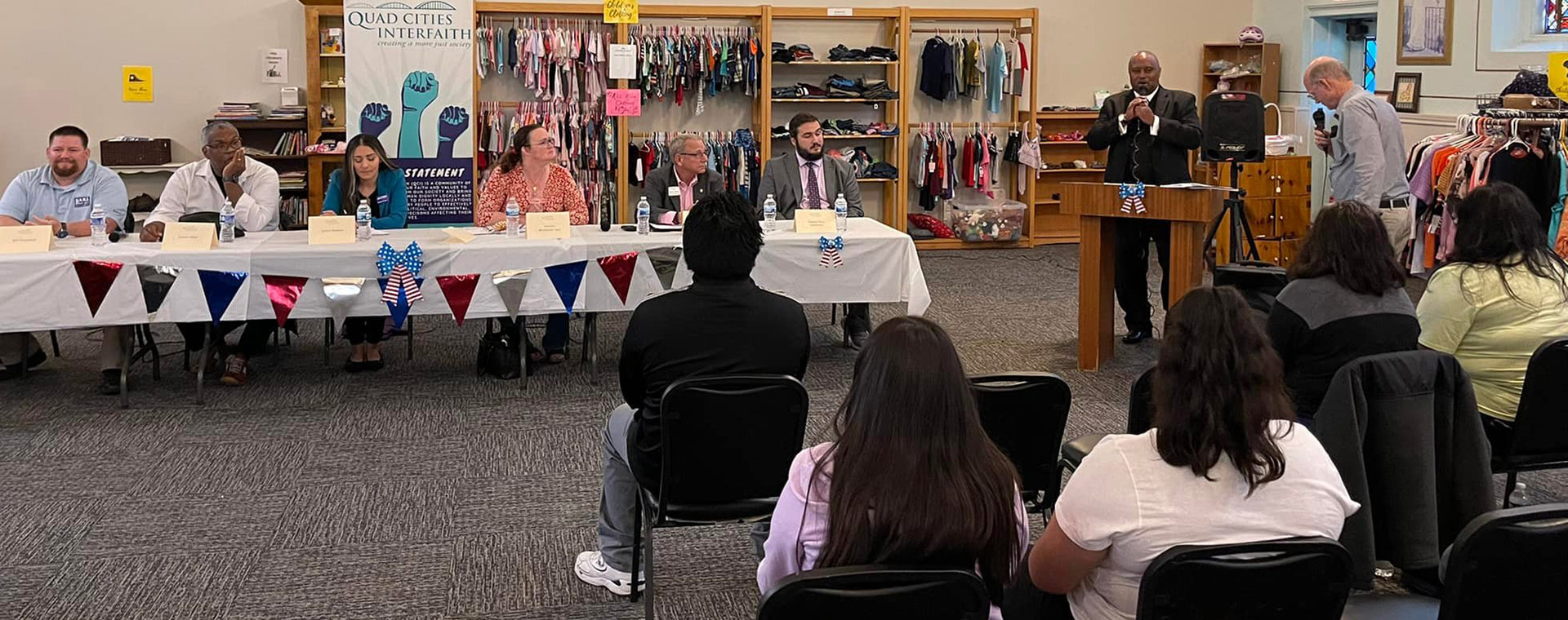 People at a table holding a town hall meeting